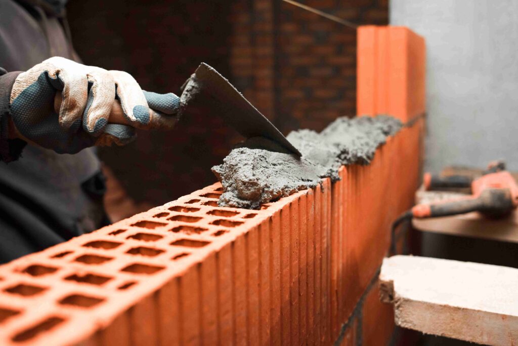 bricklayer-puts-bricks-to-make-a-wall-2022-02-02-05-53-10-utc (1)